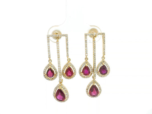 2.65 carat pear ruby and 0.91 carat diamond halo drop earrings in 18K yellow gold by Emirates Diamonds