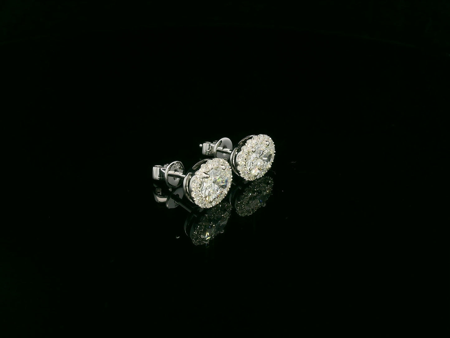 18K white gold oval cut diamond halo stud earrings with 1.40 carat GIA certified diamonds by Emirates Diamonds