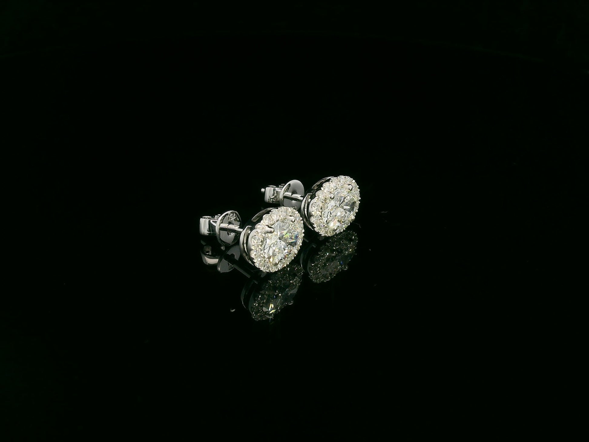 18K white gold oval cut diamond halo stud earrings with 1.40 carat GIA certified diamonds by Emirates Diamonds