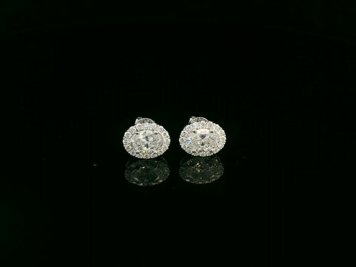 18K white gold oval cut diamond halo stud earrings with 1.40 carat GIA certified diamonds by Emirates Diamonds