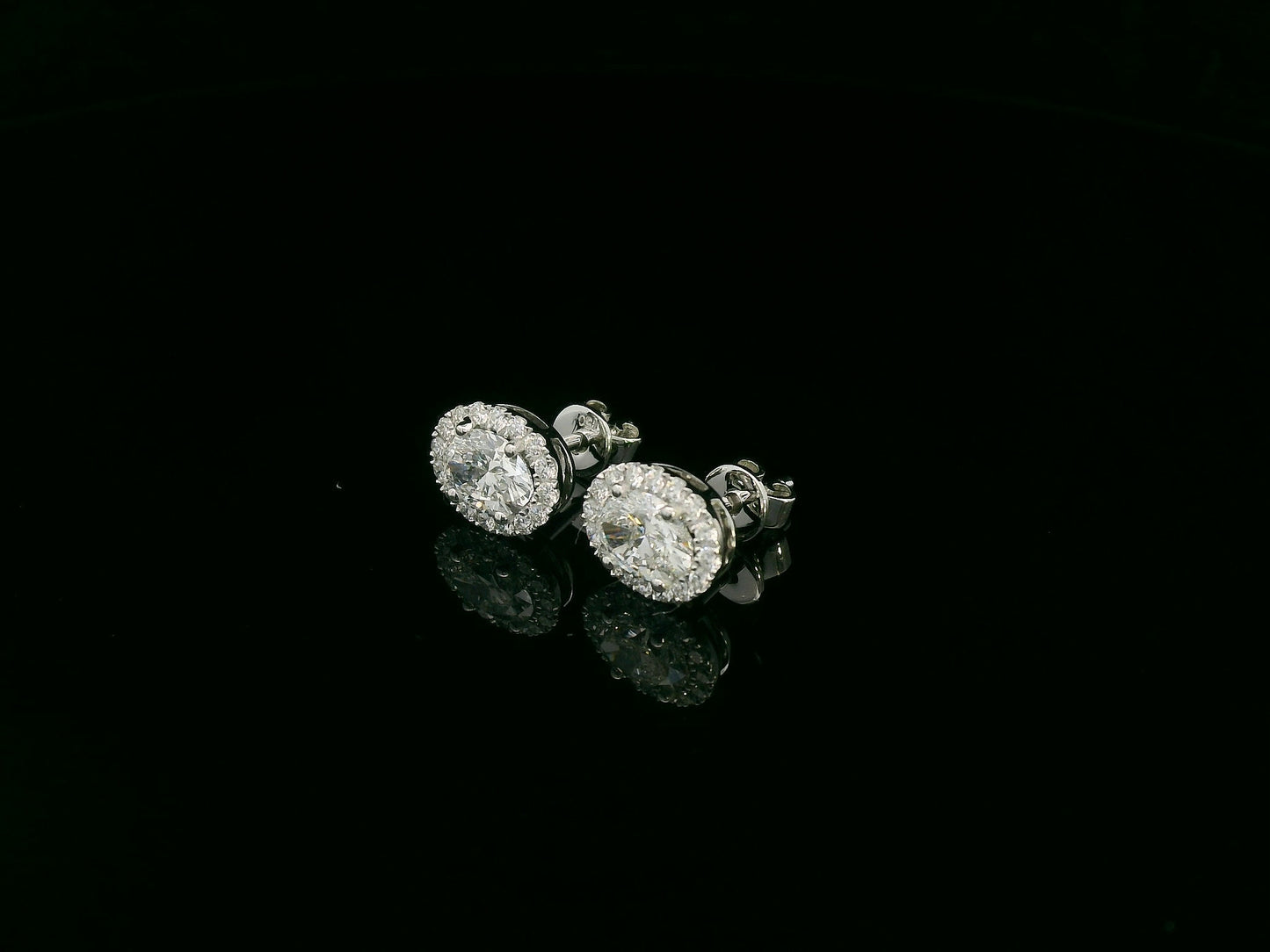 18K white gold oval cut diamond halo stud earrings with 1.40 carat GIA certified diamonds by Emirates Diamonds