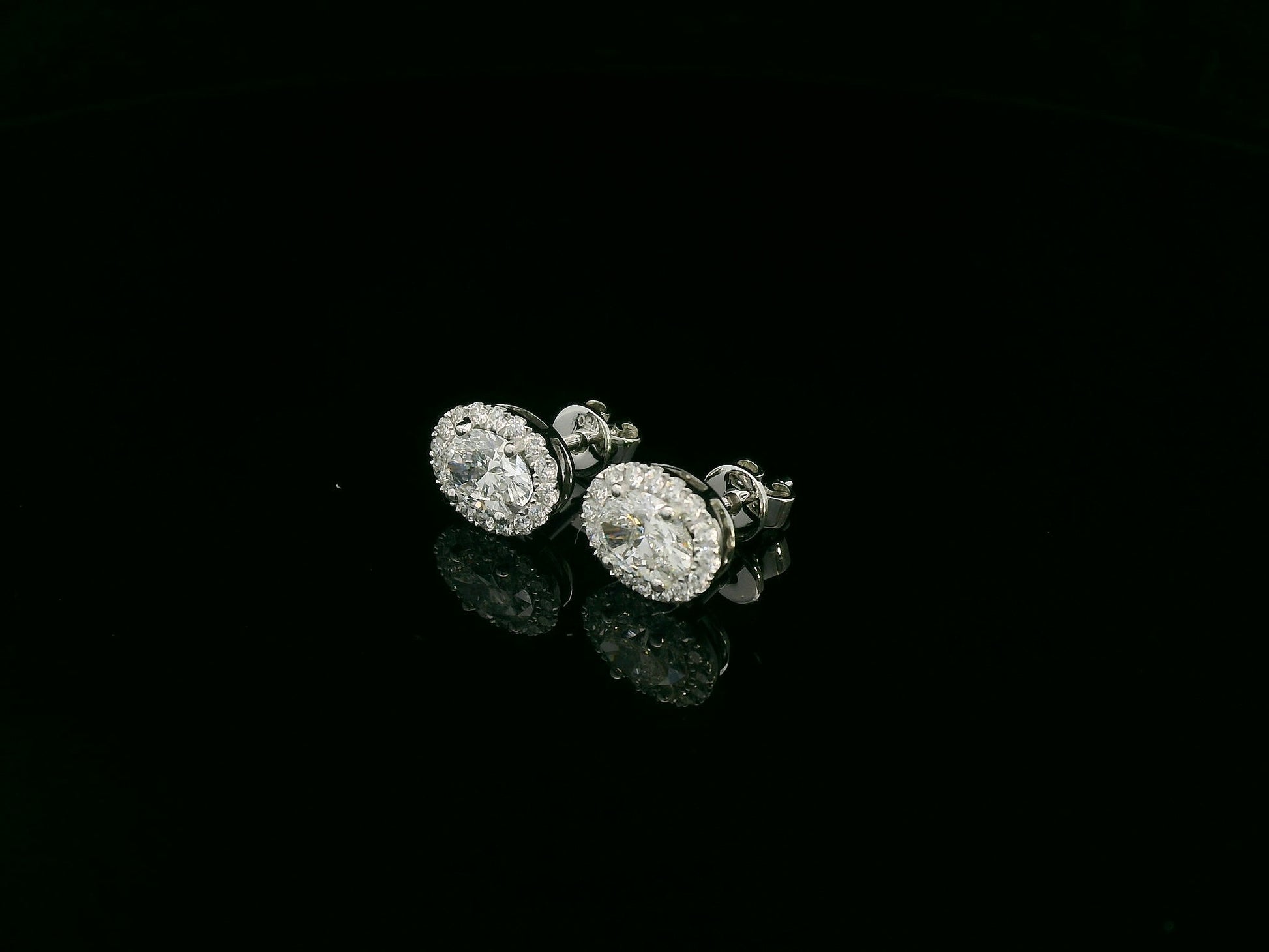 18K white gold oval cut diamond halo stud earrings with 1.40 carat GIA certified diamonds by Emirates Diamonds