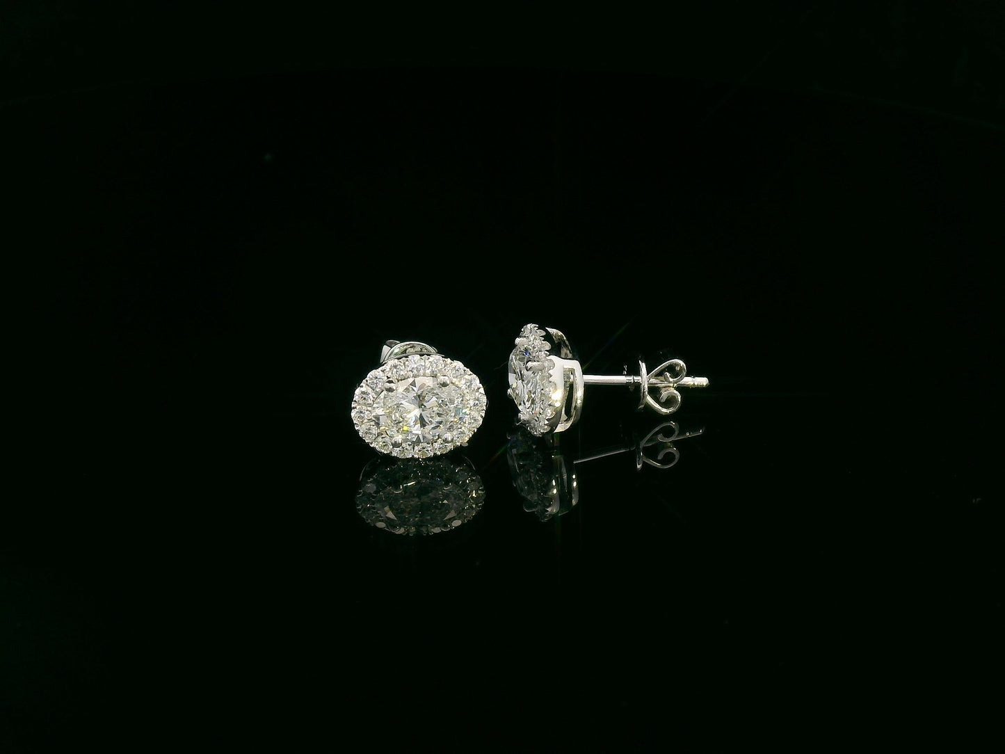18K white gold oval cut diamond halo stud earrings with 1.40 carat GIA certified diamonds by Emirates Diamonds