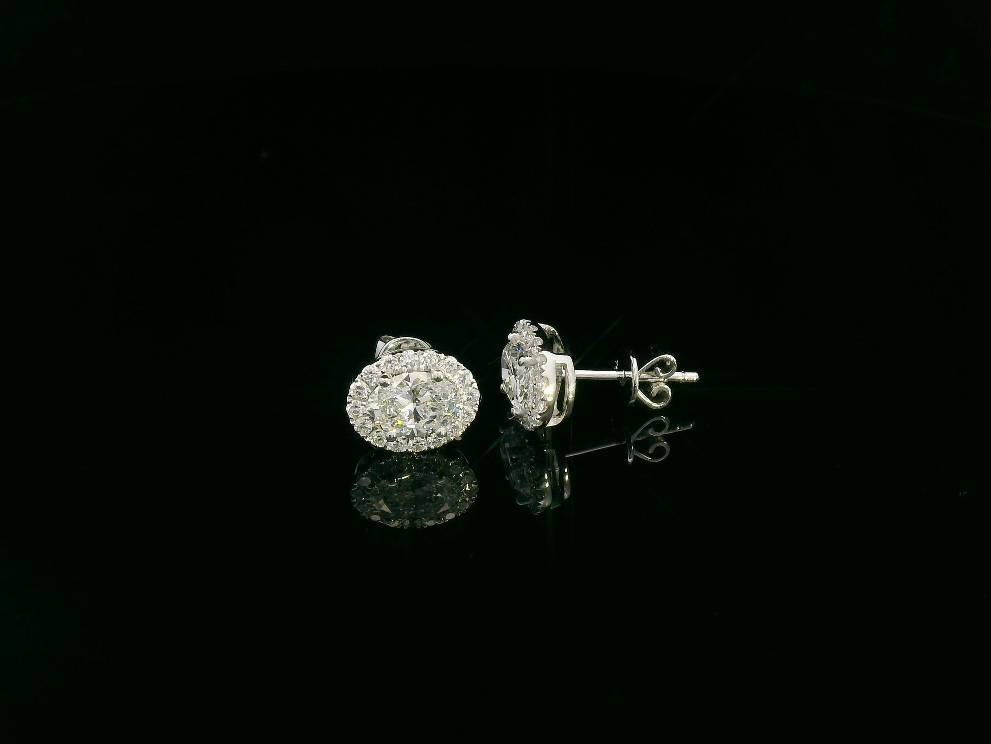 18K white gold oval cut diamond halo stud earrings with 1.40 carat GIA certified diamonds by Emirates Diamonds