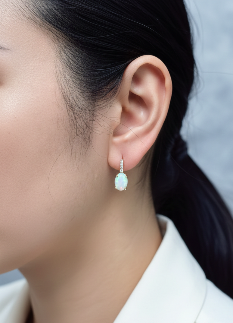 Oval opal and diamond drop earrings in 18K yellow gold by Emirates Diamonds.