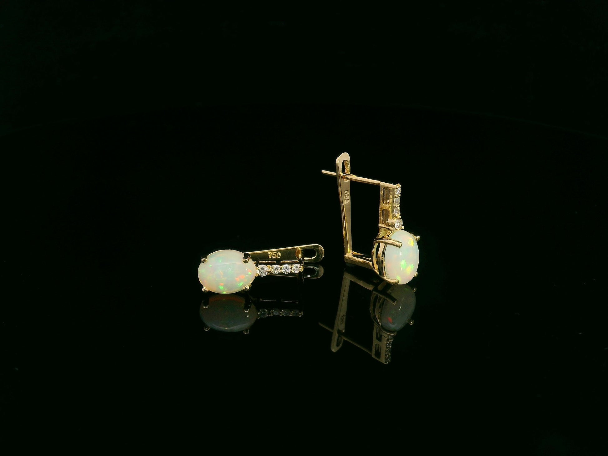Oval opal and diamond drop earrings in 18K yellow gold by Emirates Diamonds.