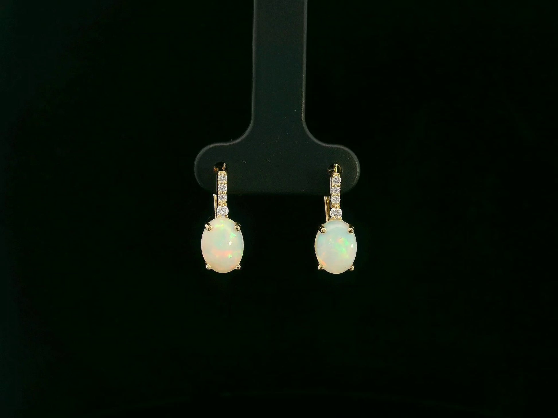 Oval opal and diamond drop earrings in 18K yellow gold by Emirates Diamonds.