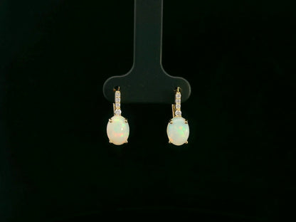 Oval opal and diamond drop earrings in 18K yellow gold by Emirates Diamonds.