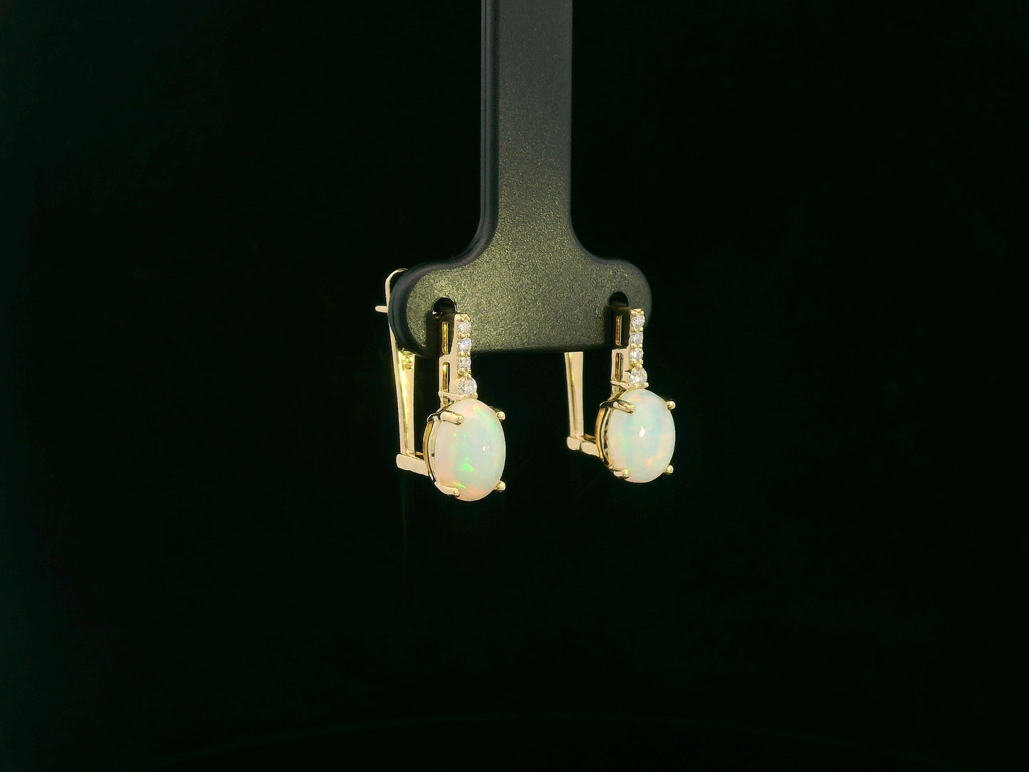 Oval opal and diamond drop earrings in 18K yellow gold by Emirates Diamonds.
