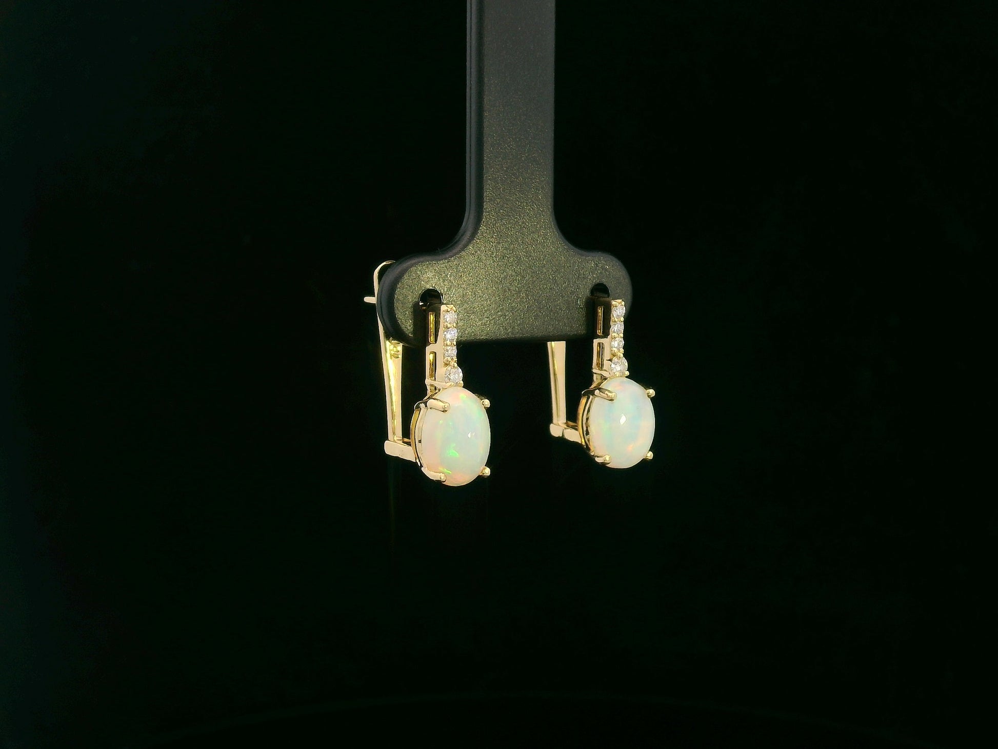 Oval opal and diamond drop earrings in 18K yellow gold by Emirates Diamonds.