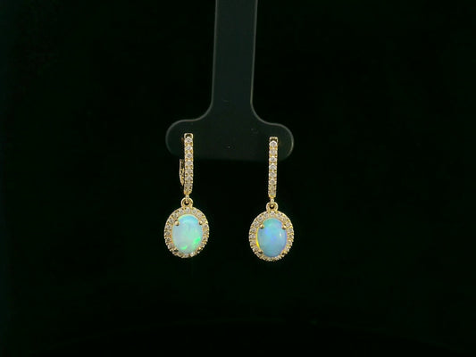 18K yellow gold opal and diamond halo drop earrings featuring oval opals and brilliant diamond accents by Emirates Diamonds.