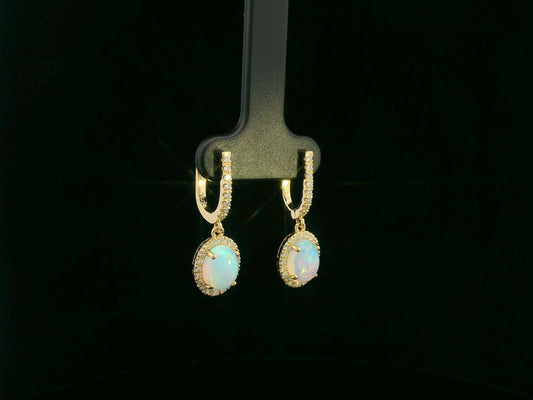 18K yellow gold opal and diamond halo drop earrings featuring oval opals and brilliant diamond accents by Emirates Diamonds.