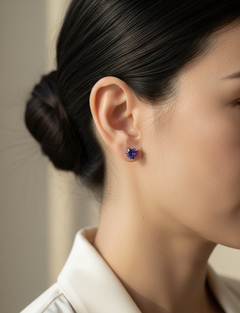 Heart-shaped tanzanite stud earrings in 18K white gold by Emirates Diamonds.