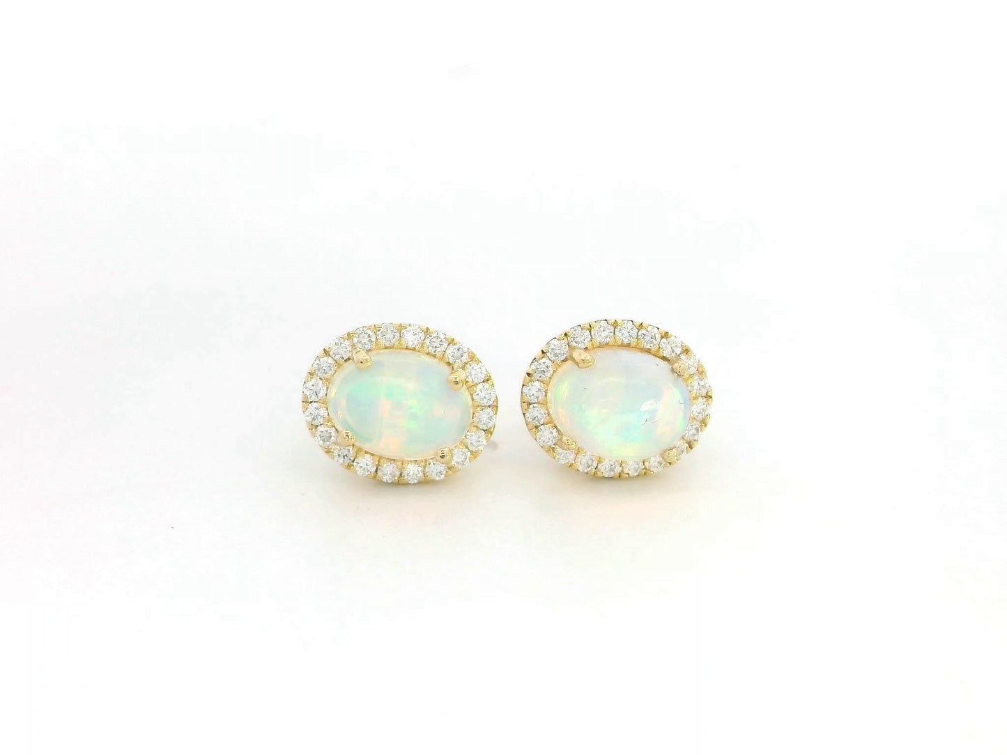 Oval opal and diamond halo stud earrings in 18K yellow gold by Emirates Diamonds.