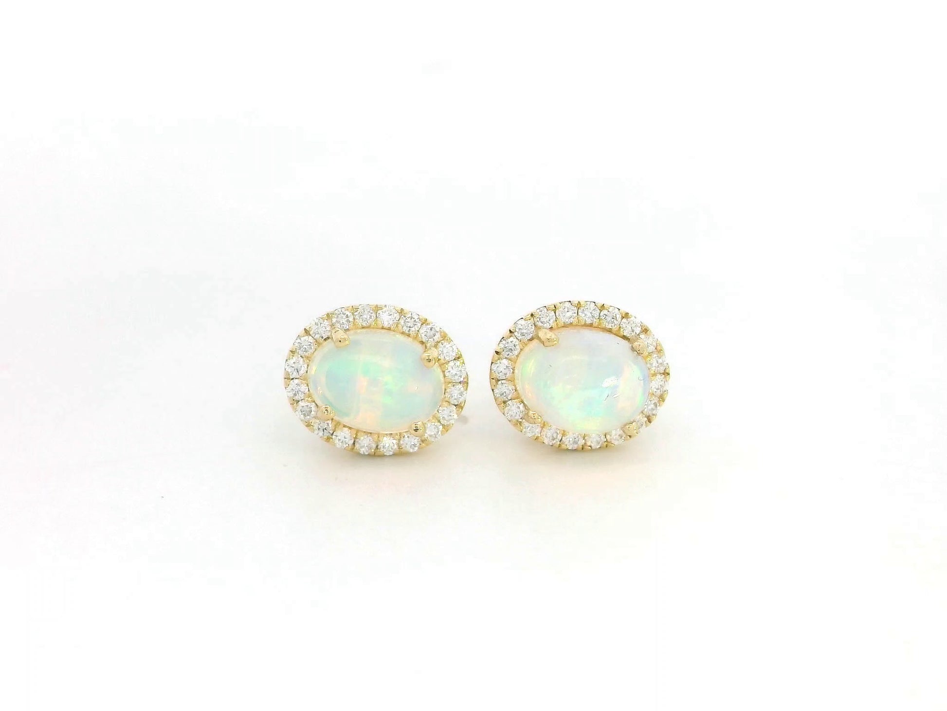 Oval opal and diamond halo stud earrings in 18K yellow gold by Emirates Diamonds.