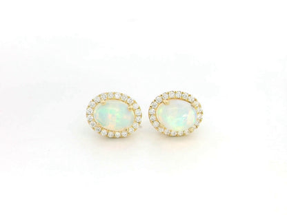Oval opal and diamond halo stud earrings in 18K yellow gold by Emirates Diamonds.