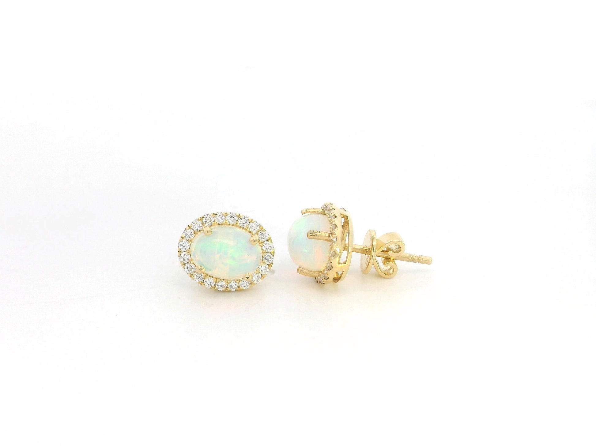 Oval opal and diamond halo stud earrings in 18K yellow gold by Emirates Diamonds.