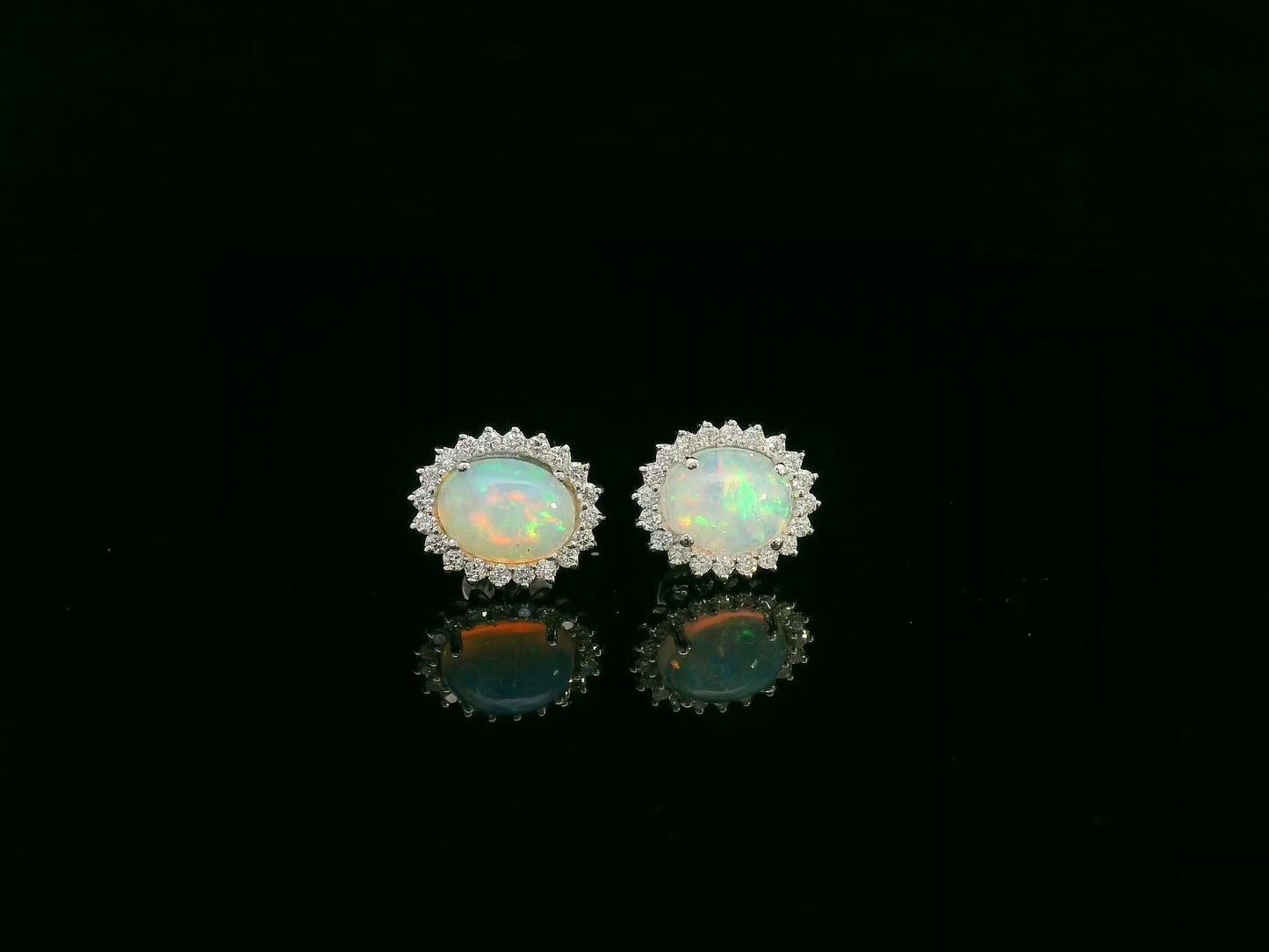 Opal and diamond halo stud earrings in 18K white gold by Emirates Diamonds.