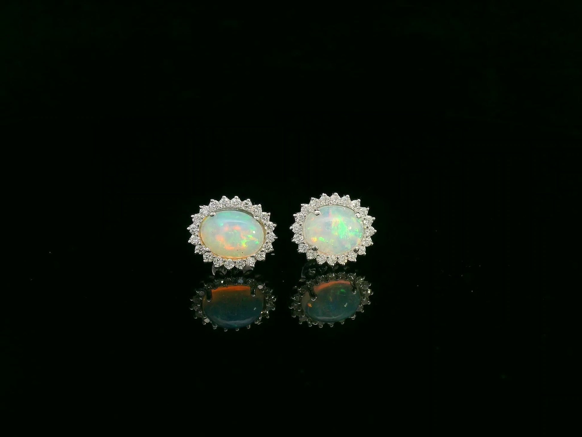 Opal and diamond halo stud earrings in 18K white gold by Emirates Diamonds.