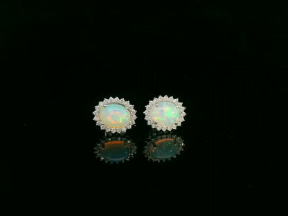 Opal and diamond halo stud earrings in 18K white gold by Emirates Diamonds.