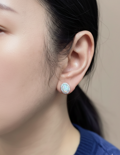 Opal and diamond halo stud earrings in 18K white gold by Emirates Diamonds.