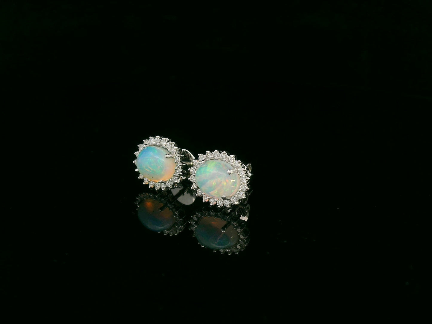 Opal and diamond halo stud earrings in 18K white gold by Emirates Diamonds.