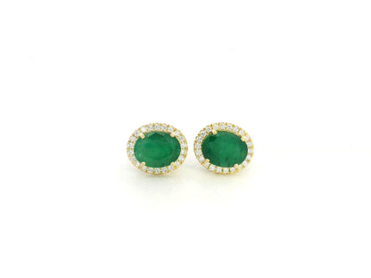 18K yellow gold emerald and diamond halo stud earrings with oval emeralds and brilliant diamond accents by Emirates Diamonds.