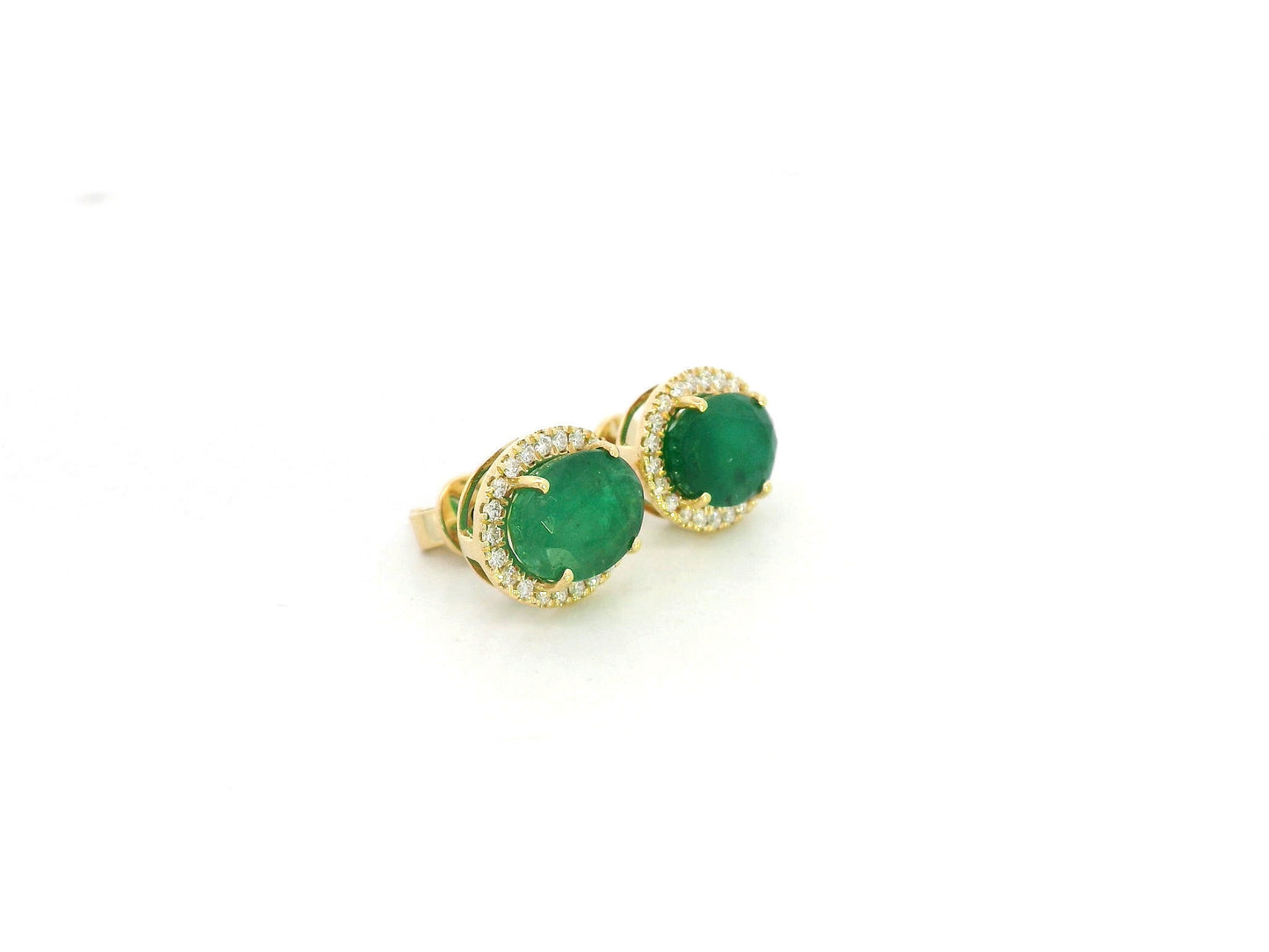 18K yellow gold emerald and diamond halo stud earrings with oval emeralds and brilliant diamond accents by Emirates Diamonds.