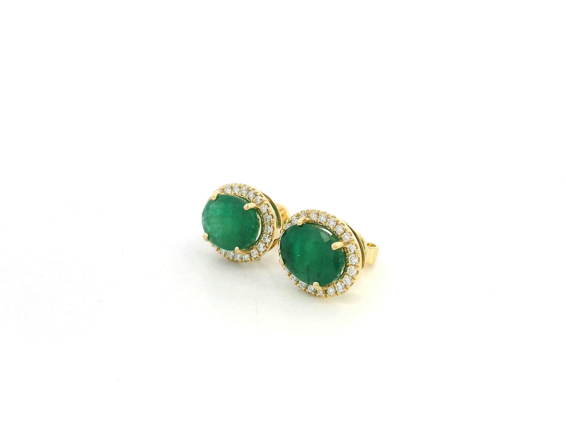 18K yellow gold emerald and diamond halo stud earrings with oval emeralds and brilliant diamond accents by Emirates Diamonds.