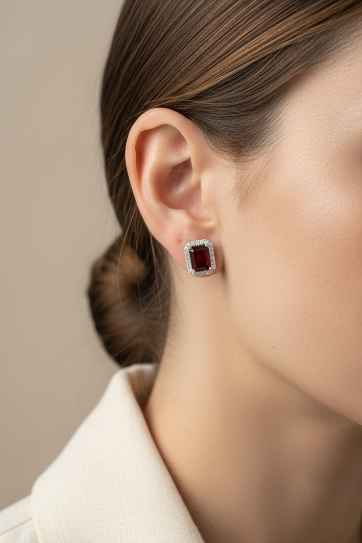 18K white gold stud earrings feature 3.34 carat emerald-cut garnets with 0.37 carat diamond accents by Emirates Diamonds.
