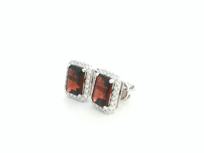 18K white gold stud earrings feature 3.34 carat emerald-cut garnets with 0.37 carat diamond accents by Emirates Diamonds.