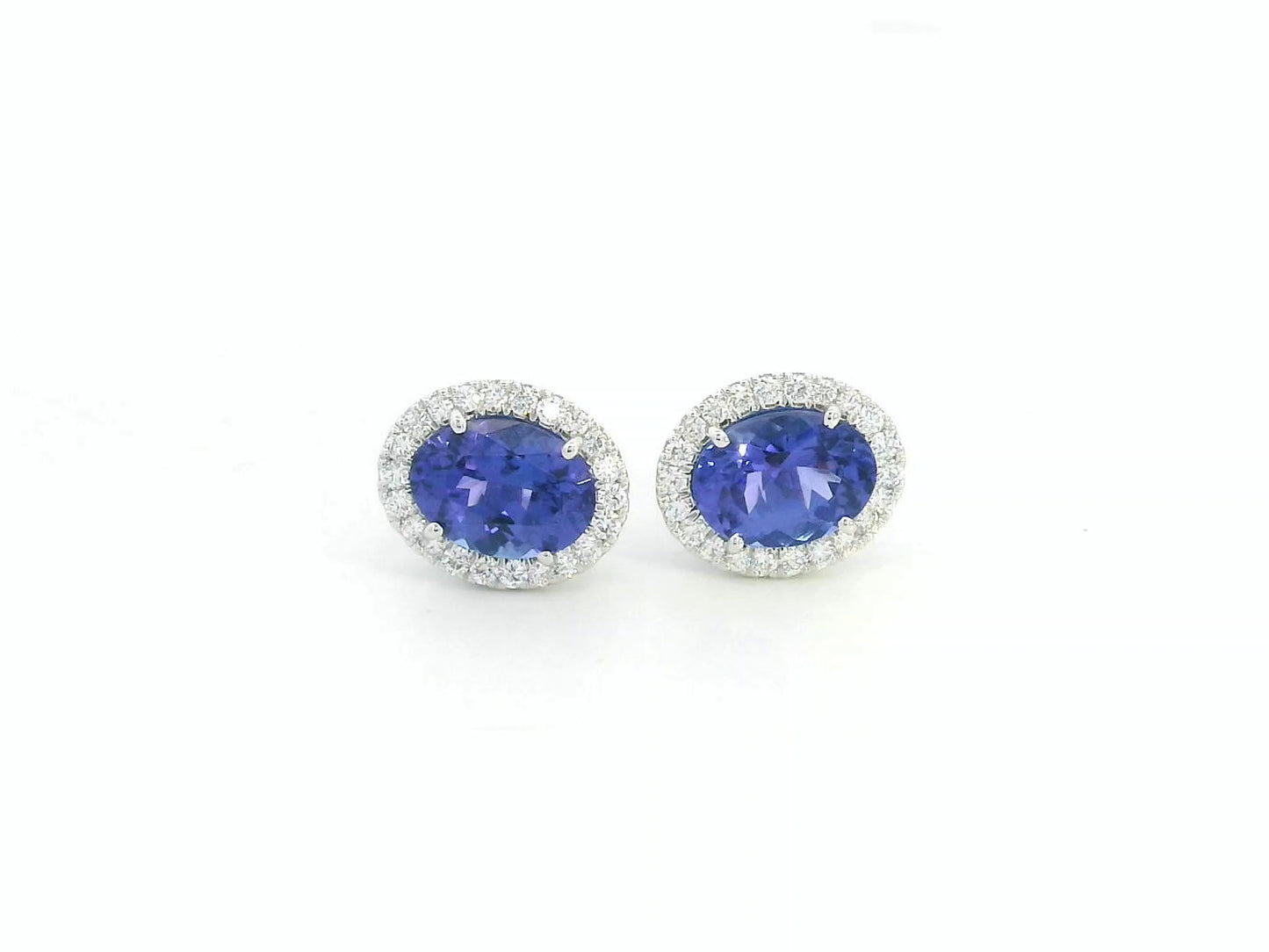 Tanzanite and diamond halo stud earrings in 18K white gold by Emirates Diamonds.