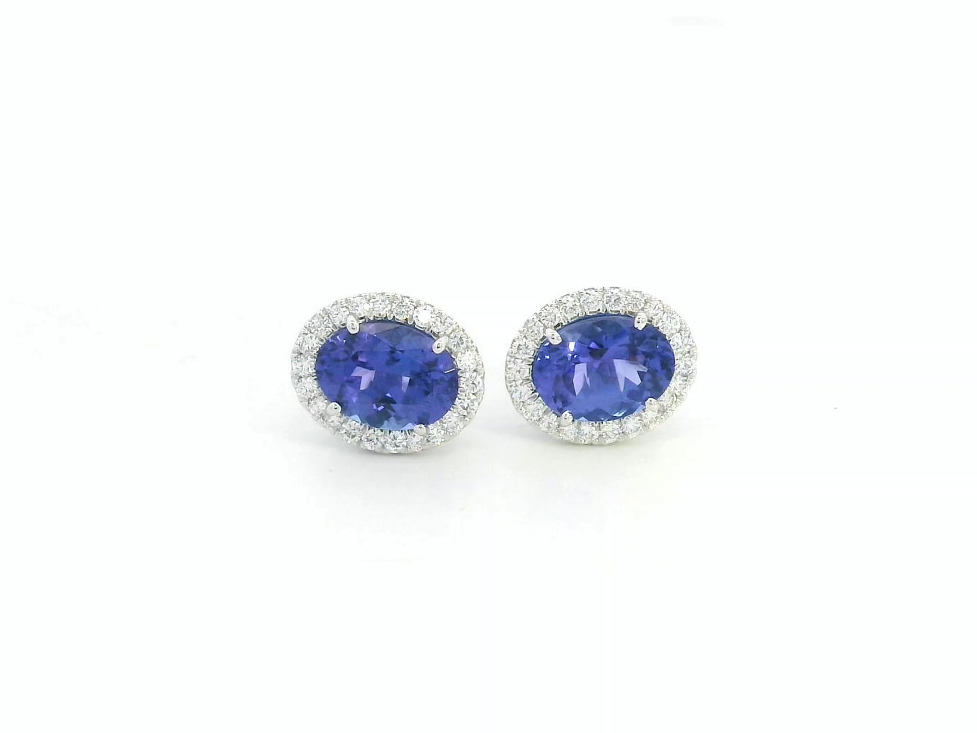 Tanzanite and diamond halo stud earrings in 18K white gold by Emirates Diamonds.
