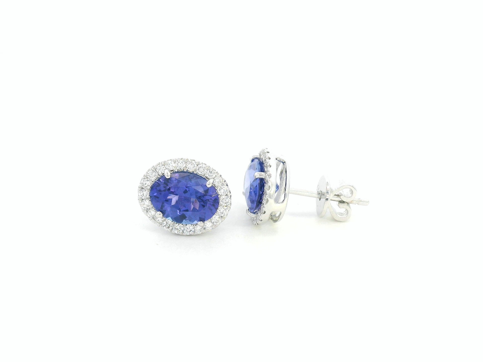 Tanzanite and diamond halo stud earrings in 18K white gold by Emirates Diamonds.