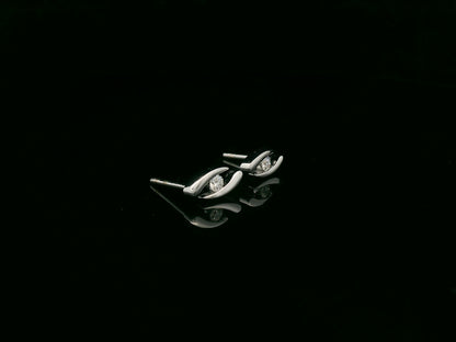 18K white gold modern diamond stud earrings with sculptural swirl design and round diamonds, total diamond weight 0.12 carat, Emirates Diamonds.