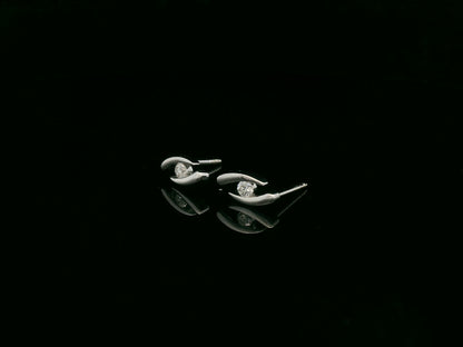 18K white gold modern diamond stud earrings with sculptural swirl design and round diamonds, total diamond weight 0.12 carat, Emirates Diamonds.