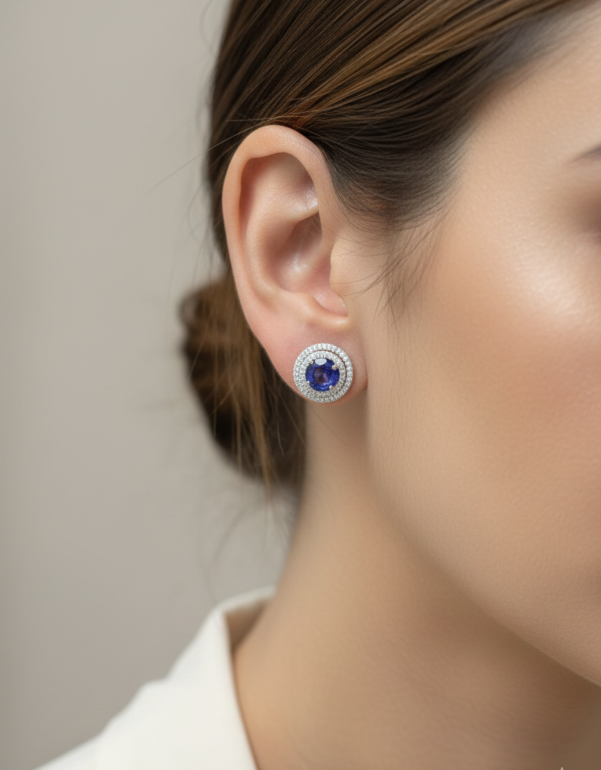 18K white gold blue sapphire halo stud earrings with diamond accents by Emirates Diamonds