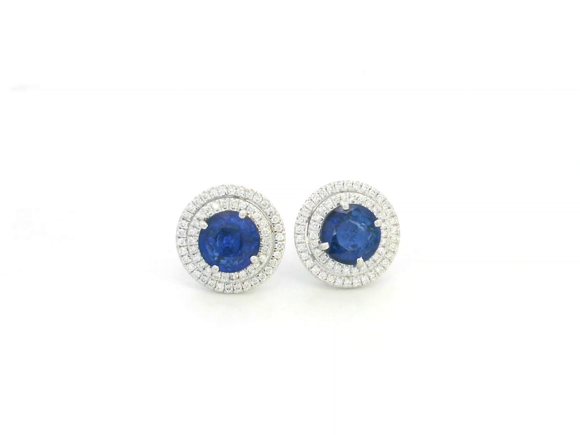 18K white gold blue sapphire halo stud earrings with diamond accents by Emirates Diamonds