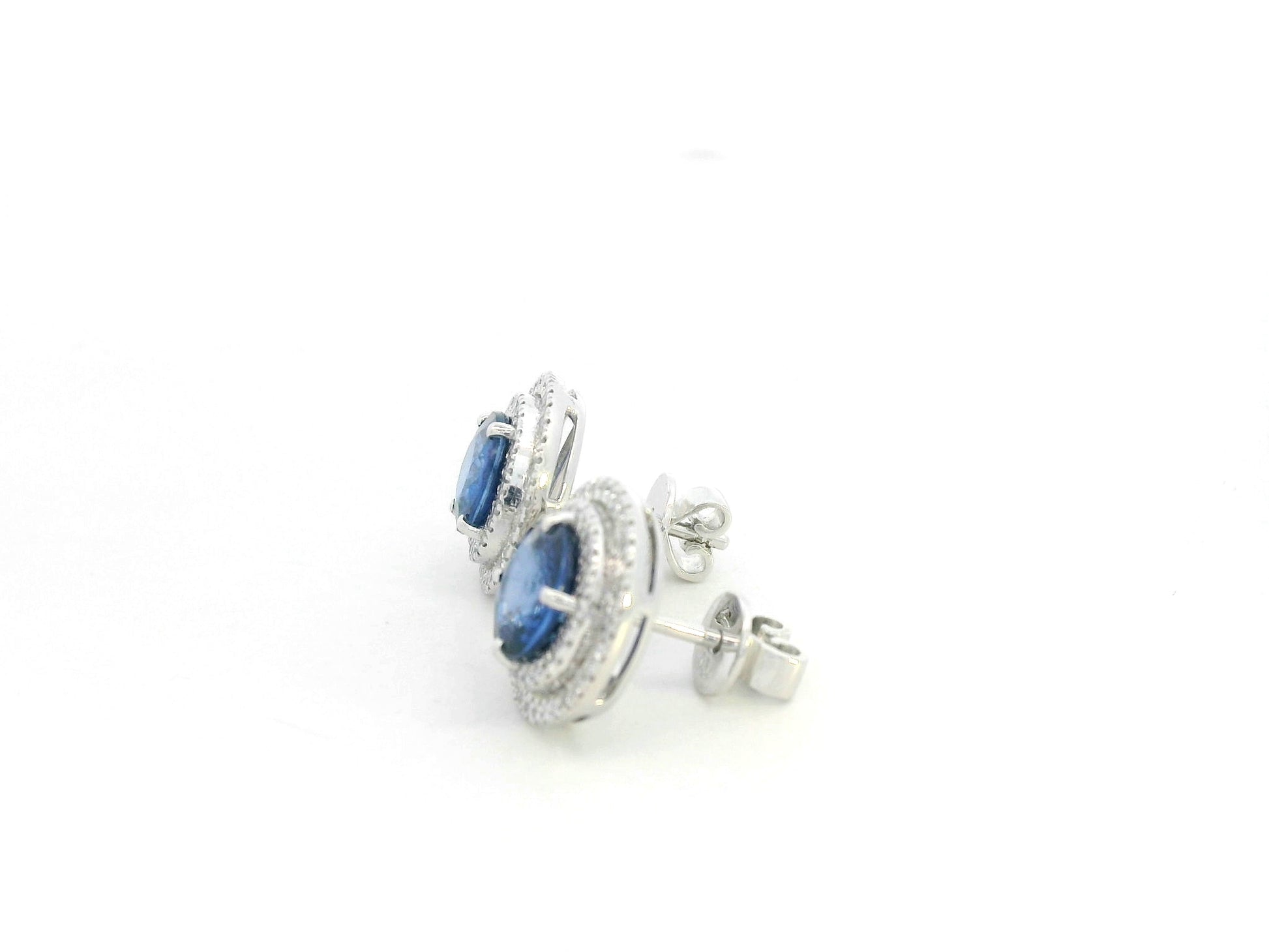 18K white gold blue sapphire halo stud earrings with diamond accents by Emirates Diamonds