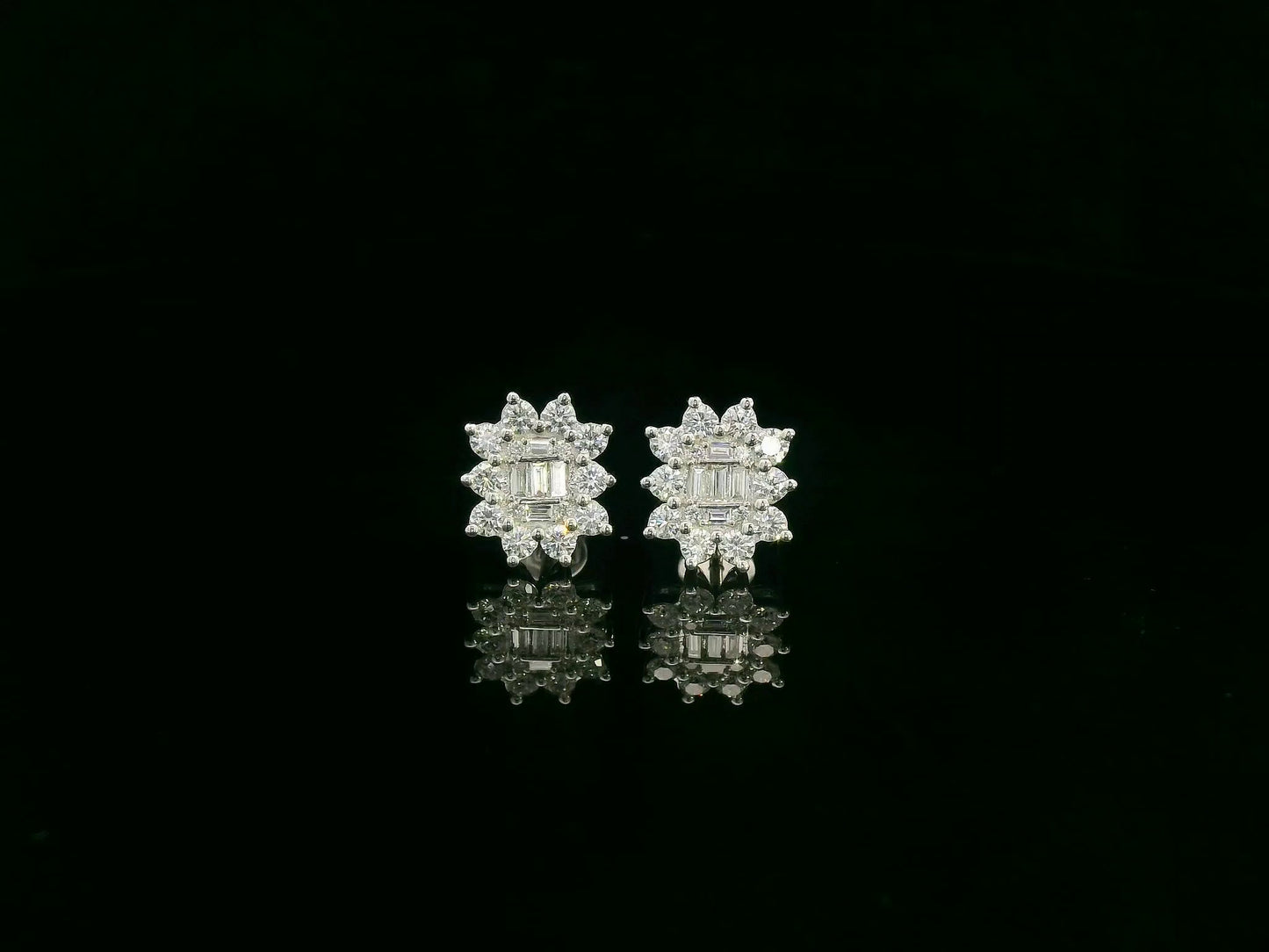 Round and baguette diamond cluster stud earrings in 18K white gold with 0.96 carat natural diamonds by Emirates Diamonds.