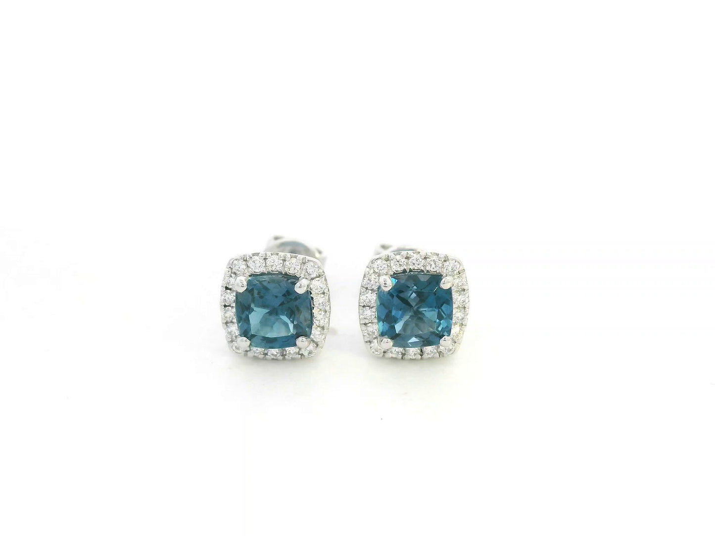 18K white gold blue topaz and diamond halo stud earrings by Emirates Diamonds