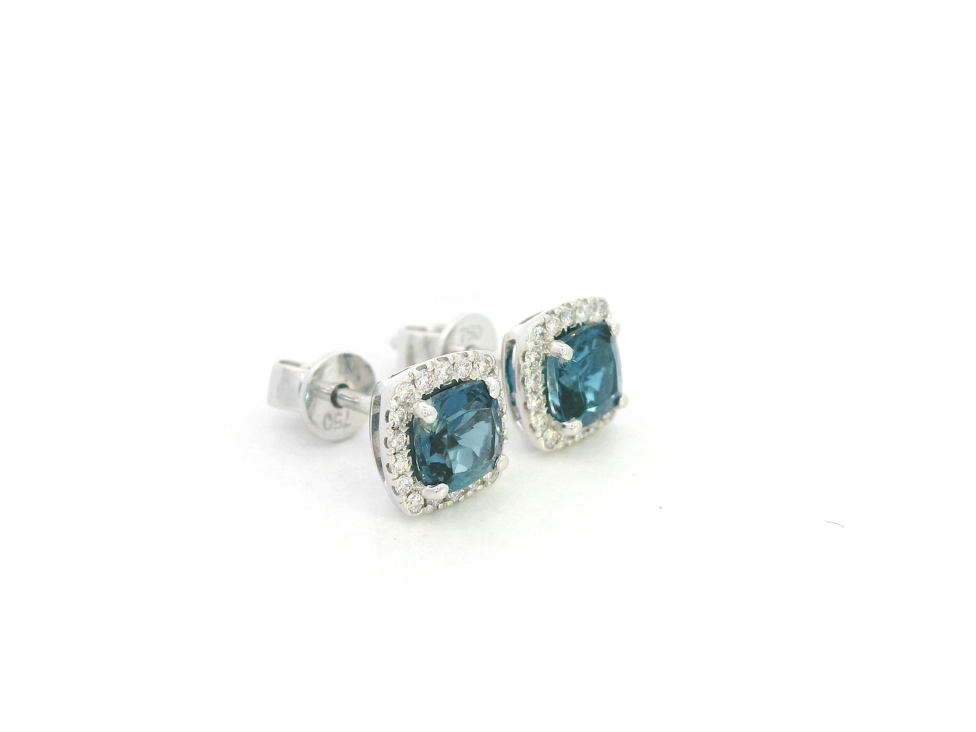 18K white gold blue topaz and diamond halo stud earrings by Emirates Diamonds