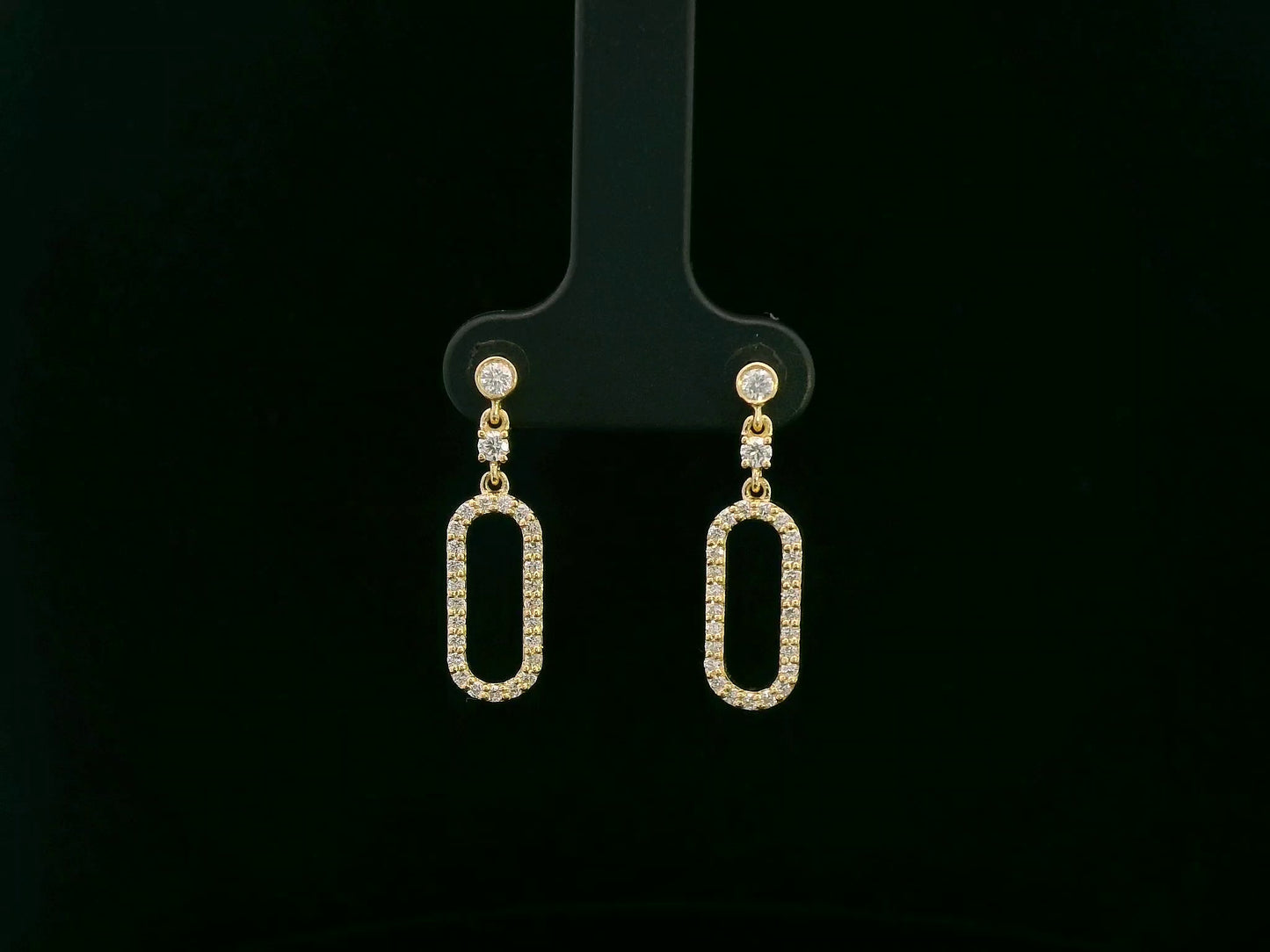 18K yellow gold diamond drop earrings featuring an elongated pavé-set oval design by Emirates Diamonds.