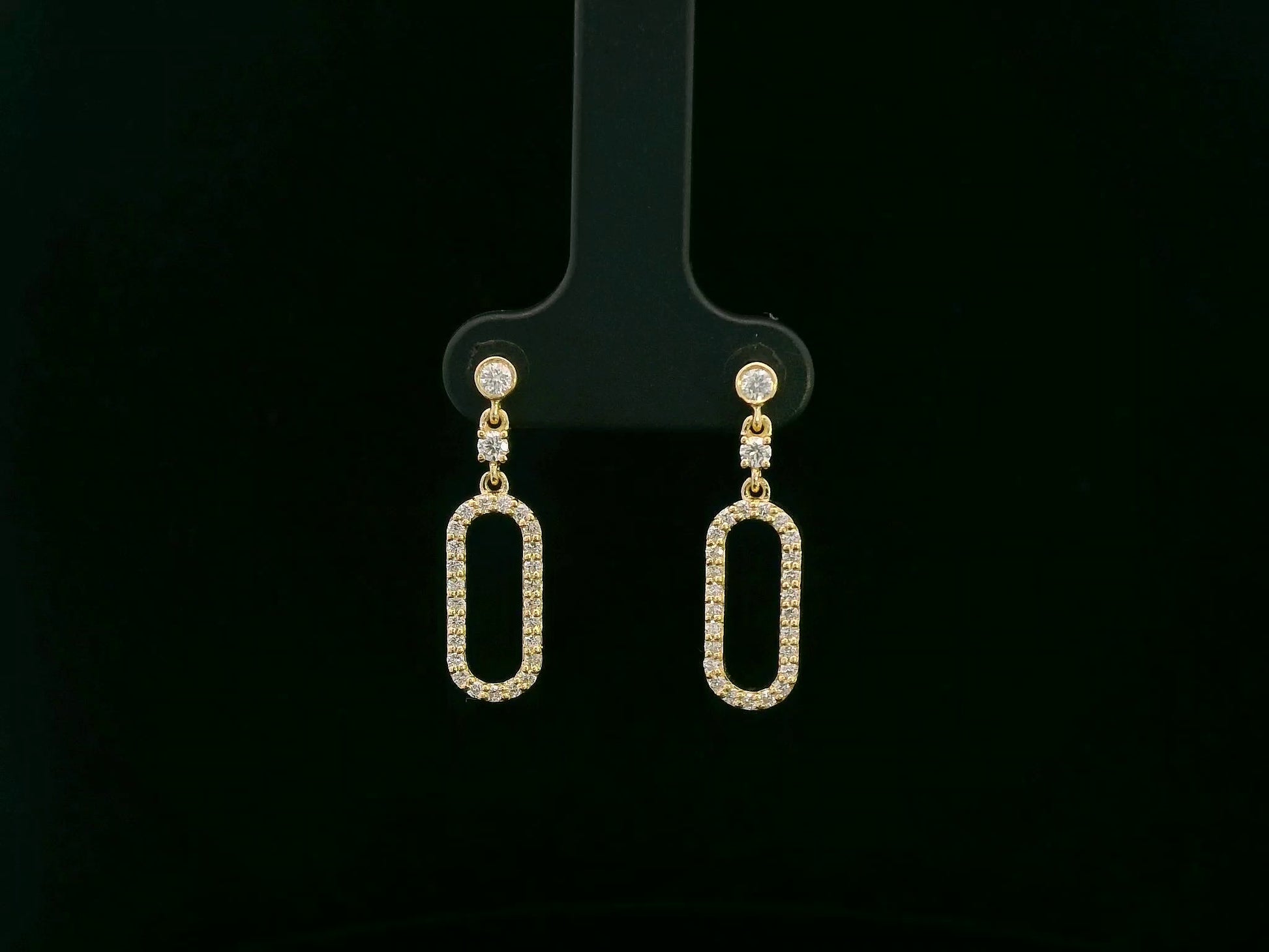 18K yellow gold diamond drop earrings featuring an elongated pavé-set oval design by Emirates Diamonds.