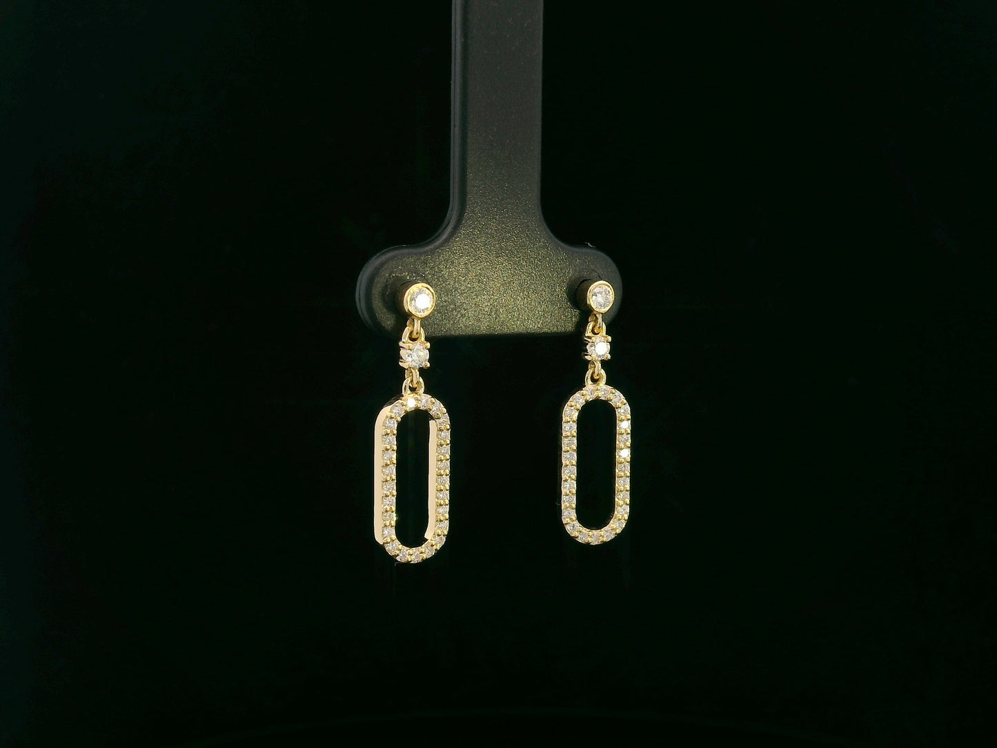 18K yellow gold diamond drop earrings featuring an elongated pavé-set oval design by Emirates Diamonds.