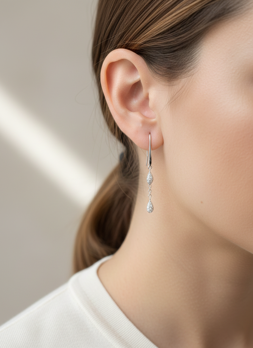 Pear-shaped diamond drop earrings in 18K white gold with 0.14 carat natural diamonds by Emirates Diamonds.