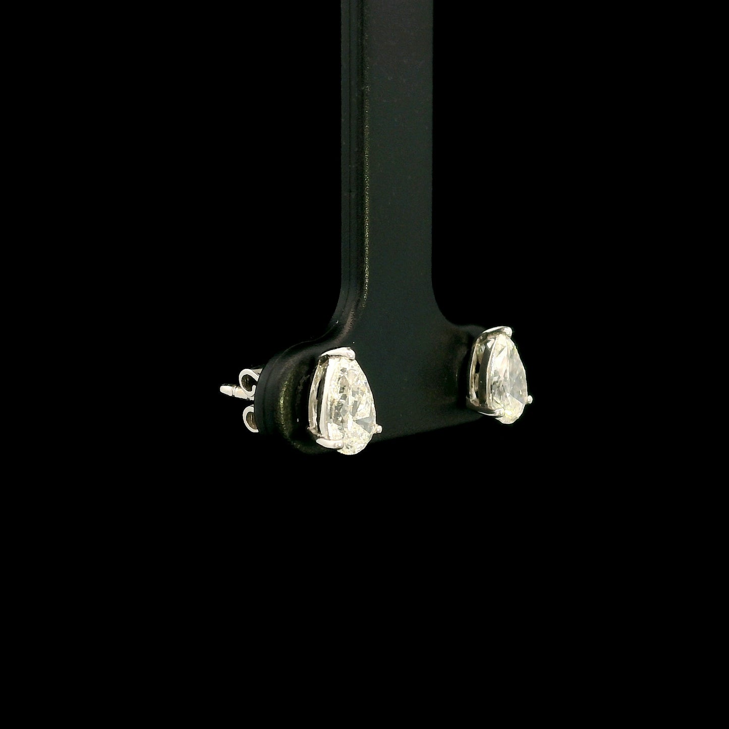GIA certified pear shape diamond stud earrings in 18K white gold with two 0.50 carat D colour VS1 natural diamonds