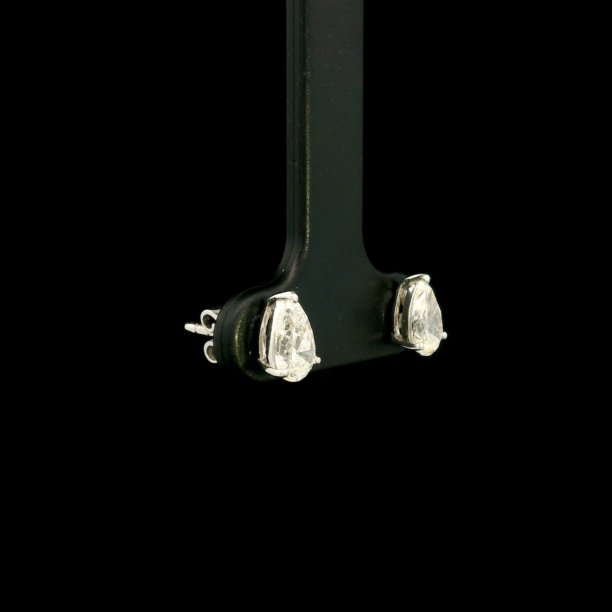 GIA certified pear shape diamond stud earrings in 18K white gold with two 0.50 carat D colour VS1 natural diamonds