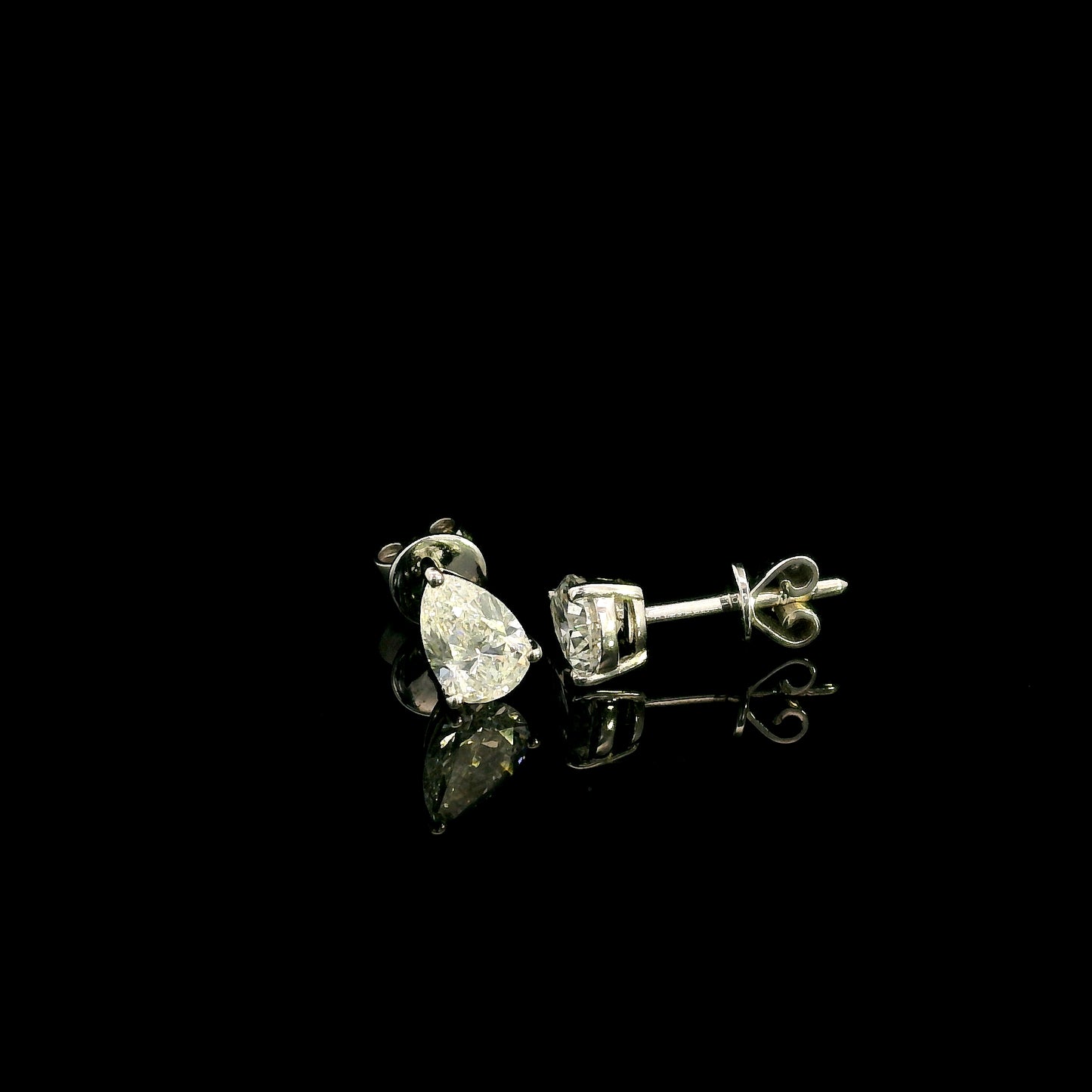 GIA certified pear shape diamond stud earrings in 18K white gold with two 0.50 carat D colour VS1 natural diamonds