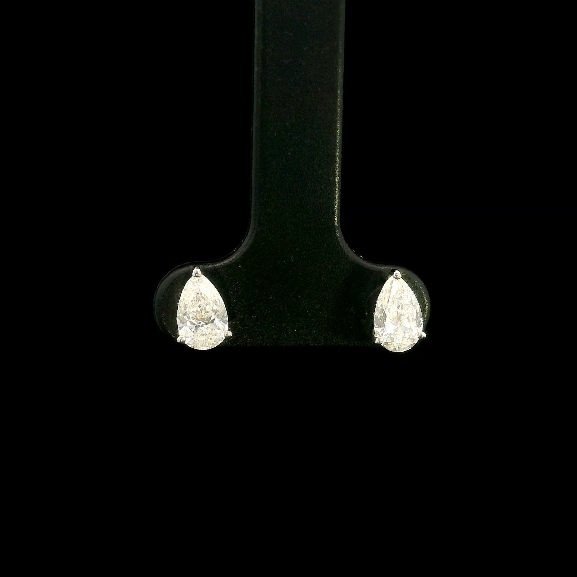 GIA certified pear shape diamond stud earrings in 18K white gold with two 0.50 carat D colour VS1 natural diamonds